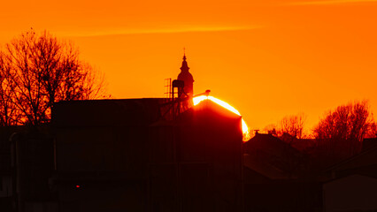 Spring sunset or sundowner with a church silhouette seen from near Arbing, Osterhofen, Deggendorf,...
