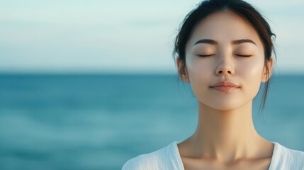 Close-up of Asian woman in deep breathing exercise by the sea