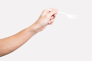 Male hand holding a white plastic fork isolated on white background.
