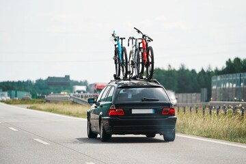Vehicles driving on a road with bikes on a rack