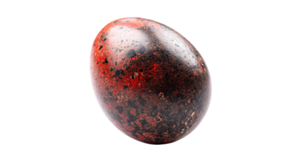 a red and black egg on a white surface