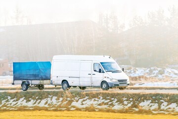 Delivery vehicle on paved road near nature