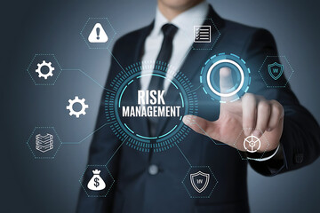 Businessman in Dark Suit Interacting with Virtual Screen Displaying "RISK MANAGEMENT", risk analysis, virtual display, risk assessment, enterprise risk, financial risk, businessman technology

