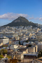 Aerial view from Anafiotika of city and limestone Mount Lycabettus, Athens, Greece