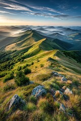 Obraz premium Vast mountain landscape stretching under a sunrise, revealing undulating ridges and valleys extending into the horizon, embraced by mist and golden light.