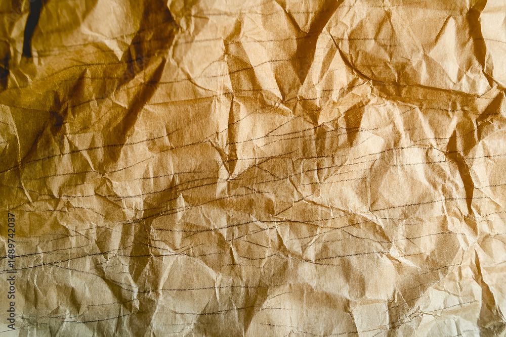 Poster close up shot of crumpled brown paper with light and shadow texture displaying its worn surface and 