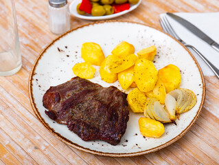 Delicious beef entrecote with fries potatoes closeup