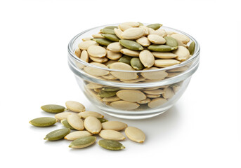 Close-up shot of a clear glass bowl filled with fresh, organic pumpkin seeds.