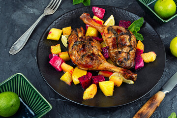 Served with tropical fruits, roast duck leg.