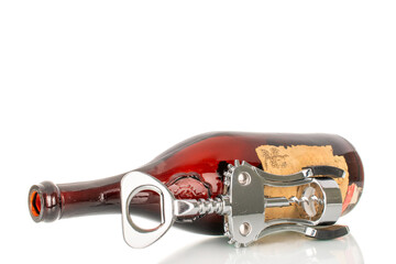 One empty bottle of old collectible wine with opener, close-up, isolated on white background.