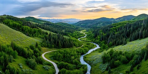 Serene river flowing through lush green valley mountain landscape nature scene peaceful environment aerial view