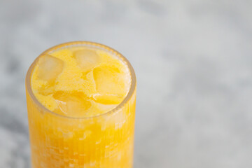 Orange Dirty Soda with Ice in Tall Glass on Grey Background, Trending Drink Concept, Copy Space