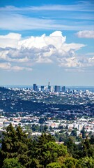 Fototapeta premium Urban Sprawl Over City Skyline with Clouds in the Blue Sky