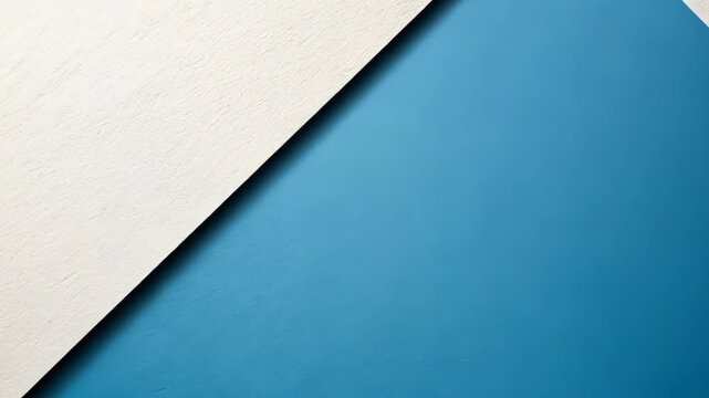 Abstract diagonal split of light blue and off-white paper surfaces