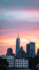 Fototapeta premium Vibrant City Skyline at Sunset with Dramatic Colorful Clouds