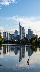 Fototapeta premium City skyline with river reflecting buildings and blue sky