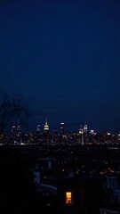 City Skyline at Night with a Single Glowing Window Storytelling