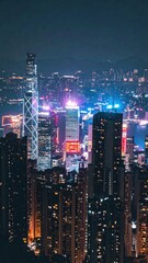 Obraz premium Vibrant City Skyline with Neon Signs at Night Over Urban Landscape