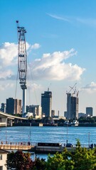City Skyline Featuring Temporary Structures Like Cranes and Observation Wheel
