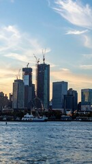 Obraz premium City Skyline with Temporary Structures and Cranes at Dusk