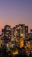 Obraz premium Serene City Skyline at Dusk with Warm Interior Light Glowing