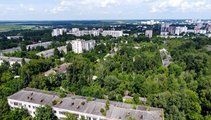 Obraz premium Overgrown Cityscape Merging Nature and Abandoned Buildings