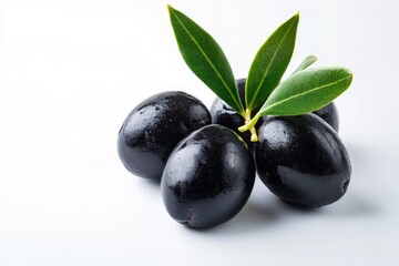 Dark, glistening olives with fresh leaves