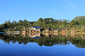 Beautiful scenery water reflection of the Chinese village at the Ruk Thai Lake in Mae Hong Son Province, Thailand