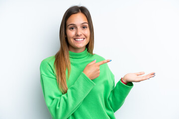 Young caucasian woman isolated on white background holding copyspace imaginary on the palm to...