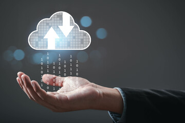A hand reaching out to a digital cloud icon, symbolizing data transfer and cloud computing...