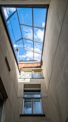 Obraz premium Rooftop Skylight View into Building with Clear Blue Sky Above