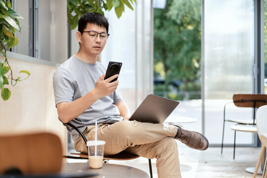 asian people wokring on laptop and smart phone