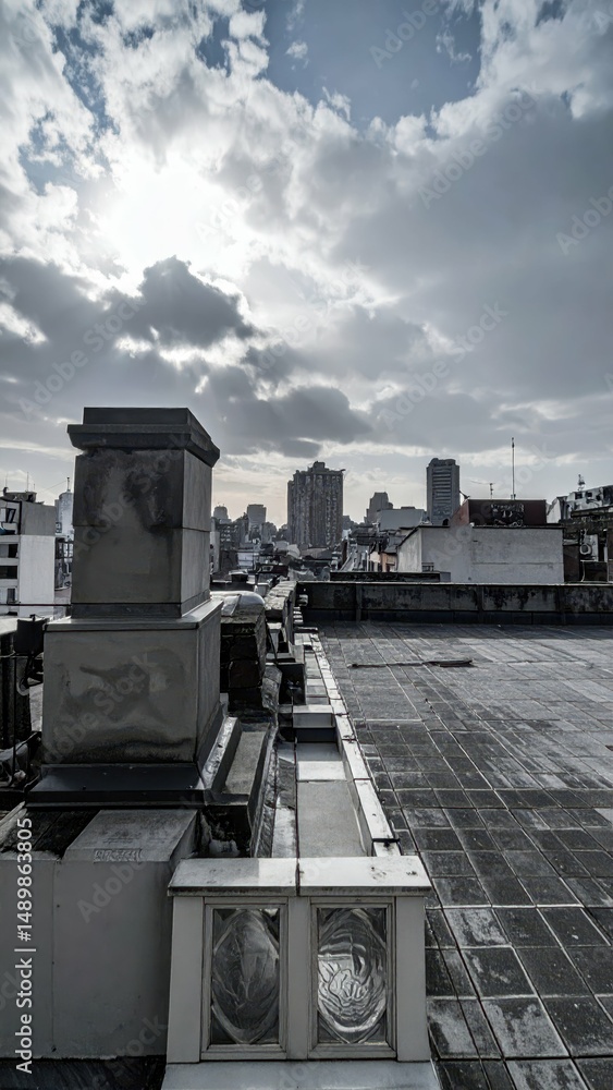 Poster serene rooftop view over cityscape with dynamic cloud patterns