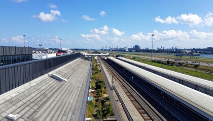Fototapeta premium Aerial View of a Transportation Hub Featuring Train Station and Airport