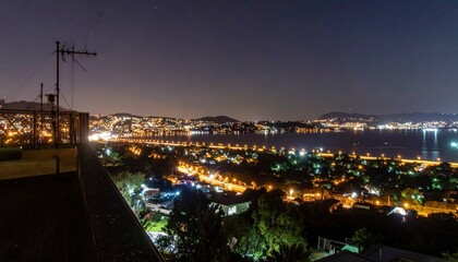 Fototapeta premium Rooftop View of City Lights and Streetlights at Nighttime