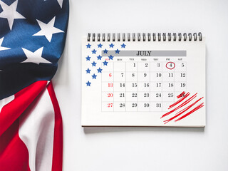 Happy Independence Day. American Flag and calendar with the date of July 4th. Calendar Marking. Greeting card. Studio shot. Congratulations for family, loved ones, relatives, friends and colleagues