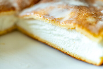 Slice of omelette poulard with pancakes on a light background. close-up