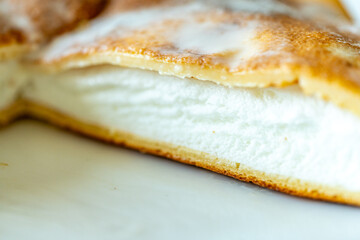 Slice of omelette poulard with pancakes on a light background. close-up