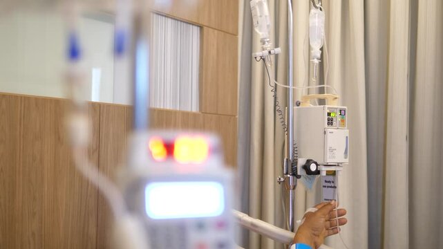 Intravenous Fluid Pump and Saline Bags in Patient Room