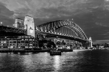 Sydney, New South Wales, Australia: Twilight view of Sydney Harbor Bridge; travel attraction in black and white