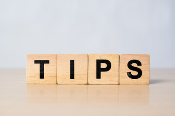 Business concept image showing the word TIPS arranged with wooden cubes on a clean background. Suitable for use in business presentations, blogs, marketing materials, and productivity content