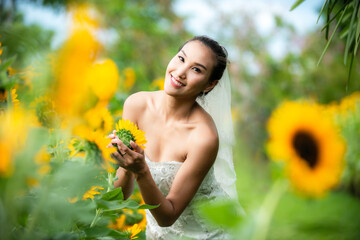 Bride holds edding bouquet. Bride wedding white dress in the garden. Nature green Background.