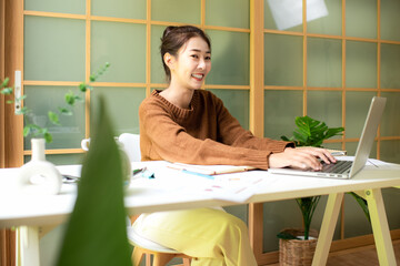oung people work from home checking report for presentation with laptop morning relax at home. Asia woman meeting conference connect online with office.  Business and Technology Concept