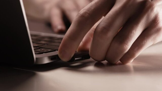 Close-up male hand unplug type-c hub with cables from laptop