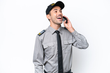 Young safeguard man over isolated white background keeping a conversation with the mobile phone
