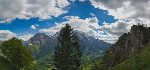 Large panorama of the Wiggis mountain with the Glarus Alps and the Klöntal lake with little water in Switzerland