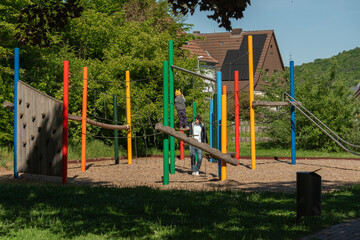 Fototapeta premium Children Playing on a Colorful Playground in Sunny Weather