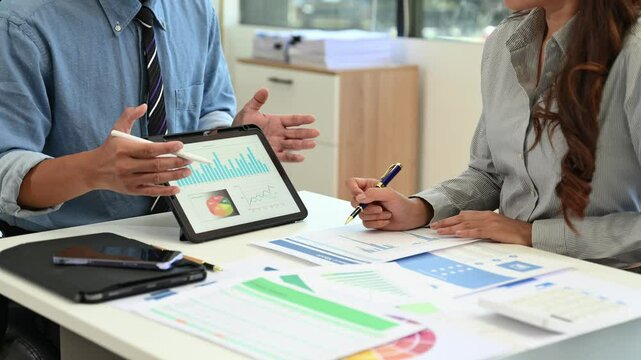 Business using a tablet and stylus for project planning. Perfect for digital office, teamwork, data presentation, and business strategy themes.