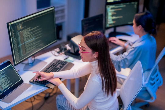 Professional computer engineer working on a new software technology design in the office Night, focus or programmer review search engine process, software or IT database development