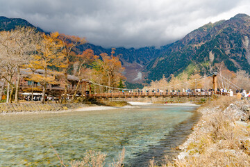 landscape view of japan alps mountain with natural forest, blue river on autumn season at Kappa bashi bridge kamikochi Nagano.
